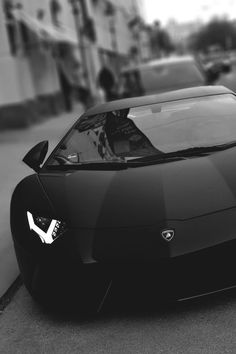 a black and white photo of a sports car