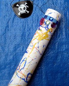 a white pipe with a skull and crossbones painted on it next to a pirate hat