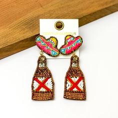 Beaded Gold Beer Bottle Earrings with Sombrero Studs. Pictured on a white background with a wood piece at the top. Green Beer Bottles, Bottle Earrings, Green Beer, Giddy Up Glamour, Bottle Charms, Beer Bottle, Sale Items, 1 Inch, Unique Style