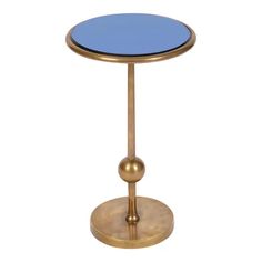 a gold and blue side table with a round glass top on an iron base, isolated against a white background