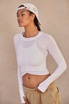 The perfect layer for every activity featured in a moves-with-you silhouette and long sleeve design with ruched bust detail for a forever flattering essential. * Crew neckline * Curved bottom hem * Soft, stretchy fit * Thumbholes in sleeves | Tempo Ruched Long Sleeve Top by FP Movement at Free People, White, XS Fitted Ruched Yoga Tops, Ruched Stretch Workout Tops, Stretch Ruched Workout Tops, Stretch Ruched Tops For Workout, Sporty Stretch Ruched Tops, Fitted Long Sleeve Top With Ruched Sides, Spring Fitted Ruched Activewear, Spring Stretch Activewear With Ruched Details, Casual Fitted Long Sleeve Ruched Top