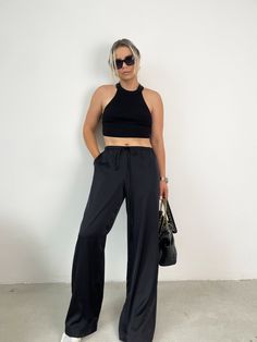 high waisted wide leg silk trousers in black, silk trousers, silk pants, black silk pants, plus size silk pants Black Silk Wide Leg Bottoms, Black Silk Wide-leg Pants, Silk Wide Leg Pants For Night Out, Black Wide Leg Pants With Elastic Waistband For Evening, Elegant Black Wide Leg Pants For Evening, Chic Black Silk Bottoms, Black Wide Leg Pants For Summer Evenings, Black Silk Pants For Night Out, Black High Waist Satin Pants