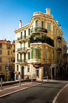 an old building with balconies and green shutters on the windows is shown