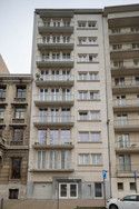 an apartment building with cars parked in front