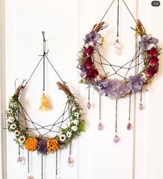 two wreaths hanging from the side of a door with beads and flowers on them