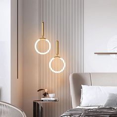 a bed room with a neatly made bed and two lights hanging from the wall above it