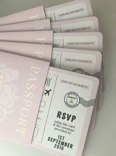 a bunch of pink tickets sitting on top of a white table next to each other