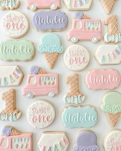 decorated cookies are arranged in pastel colors and the words'sweet one'on them