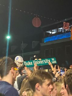 a group of people holding up signs in the air