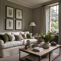 a living room filled with lots of furniture next to a table and two large windows