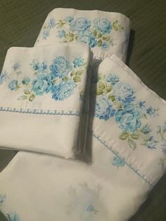 four pieces of white and blue floral bedding