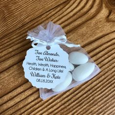 some white eggs are in a bag on a wooden table with a tag that says true almonds, five wishes health, well - worth happiness, children & long life