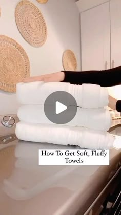 a woman standing on top of a kitchen counter next to white towels and an oven with the words how to get soft, fluffy towels