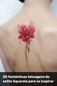 a woman's back with a red flower tattoo on it