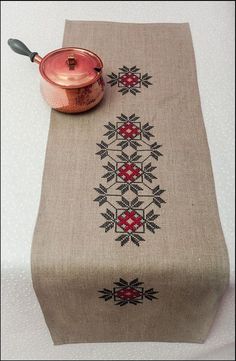 a table runner with a pot on it