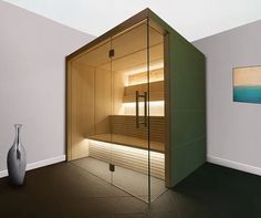 an empty sauna in the corner of a room with a painting on the wall