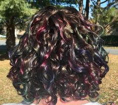 Oil Slick Hair Color Curly, Short Curly Peekaboo Hair, Curly Hair Rainbow Highlights, Oil Slick Curly Hair, Peekaboo Oil Slick Hair, Curly Hair With Colored Streaks, Curly Hair Peekaboo, Under Hair Dye Curly, Peekaboo Curly Hair