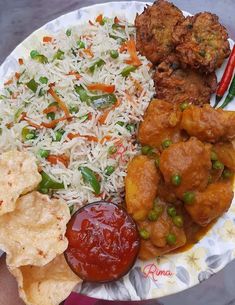 a white plate topped with rice, meat and veggies