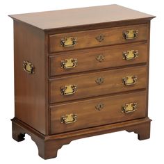 an antique chest of drawers with brass hardware on the top and bottom, in dark wood