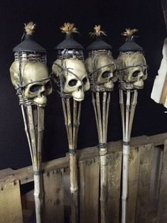 three skulls are sitting on top of sticks