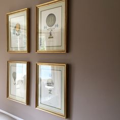 three framed pictures hang on the wall above a bed