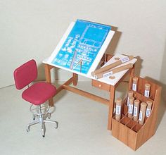 a desk with a chair and easel next to it