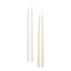 two white candles sitting next to each other