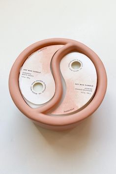 two pink bowls sitting next to each other on a table