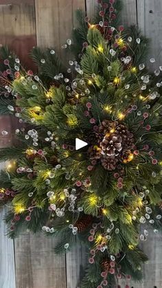 a christmas wreath with pine cones and lights