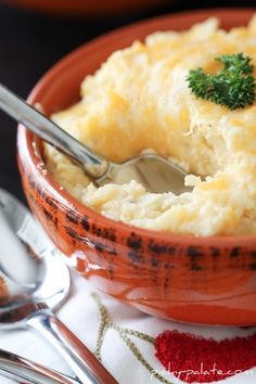 a bowl filled with mashed potatoes and garnished with parsley