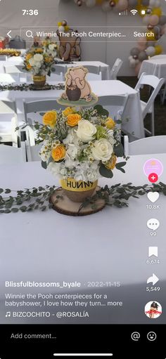 the table is set up for an event with white and yellow flowers in vases