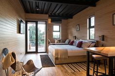 a bedroom with wooden walls and flooring