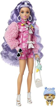 a barbie doll is standing next to a small dog and holding a toy in it's hand