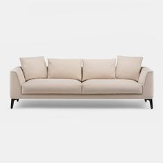 a beige couch with four pillows on the back and one arm folded out to show it's shape