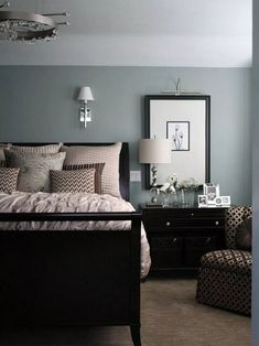 a bedroom with blue walls and brown furniture