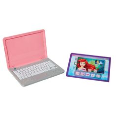 an open laptop computer sitting next to a pink case