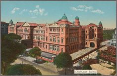 an old postcard shows a large building in the middle of a city with trees and buildings around it