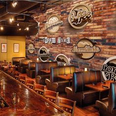 the interior of a restaurant with wooden tables and brown leather chairs, exposed brick walls