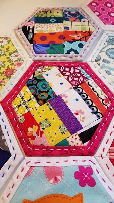 several patchwork pieces are arranged on top of each other in different colors and patterns