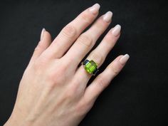 A beautiful pairing of bright colors and sleek shapes form this modern version of a classic 3-stone ring. This stylish ring features a gorgeous, 5.12 carat emerald-cut peridot flanked on either side by emerald-cut rich blue sapphires. The peridot has been set in yellow gold to highlight its warm color, while the blue sapphires have been set in striking white gold, creating a lovely, eye-catching contrast. So pretty and wearable! Handcrafted in 18k white and yellow gold by our Master Jewelers in Yellow Gold Cocktail Ring, 3 Stone Rings, Gold Cocktail Ring, Gold Cocktail, Blue Sapphire Diamond, Stylish Rings, Green Peridot, Dress Rings, Blue Zircon