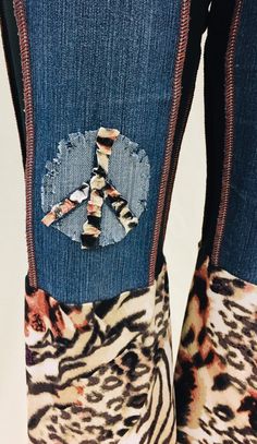 The most comfortable jeans you'll ever wear. One of a kind jeans with the Mama Mia ruffle will turn heads. Comfort and funky hippie style. Embellished with denim peace sign. These get noticed. SIZE XXS-L. You will need to size down. XXS - 0-4 XS-6-8 S- 8-12 M-12-14 L-16-18 Casual Jeans For Festival In Fall, Hippie Denim Bottoms For Fall, Hippie Straight Leg Jeans For Fall, Hippie Wide Leg Jeans For Fall, Fall Festival Denim Flare Jeans, Trendy Stretch Jeans For Festivals, Hippie Denim Blue Bottoms, Trendy Fitted Bottoms With Patches, Casual Stretch Jeans For Festival