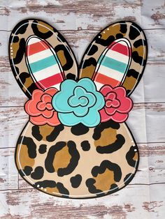 an animal print bunny ears with flowers on it