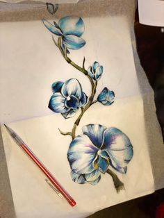 a piece of paper with blue flowers on it and a red pencil next to it