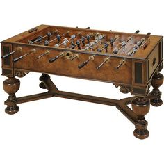 an old wooden table top foosball with many pieces of metal in the drawer