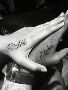 two people with matching tattoos on their hands holding each other's hand and the words aloh, ahoh, ohoh written in curs