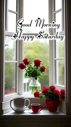 a vase filled with red roses sitting on top of a window sill next to two cups