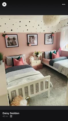 a bedroom with two beds and pictures on the wall above them, along with other furniture