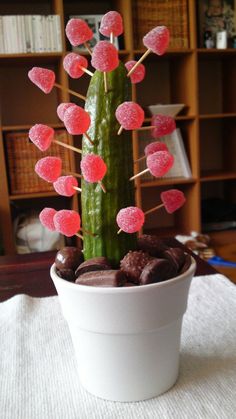 a potted plant sitting on top of a table filled with chocolate covered candies