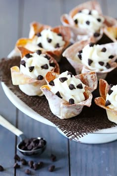 cupcakes with white frosting and chocolate chips on a plate