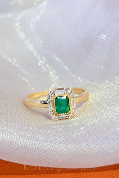 Formal Emerald Ring With Rectangular Stone, Rectangular Emerald Ring With Baguette Diamonds For Formal Occasions, Rectangular Emerald Ring With Baguette Diamonds For Formal Events, Diamond Ring With Baguette Diamonds And Rectangular Stone, Rectangular Halo Setting Rings In Fine Jewelry, Rectangular Emerald Ring With Halo Setting, Rectangular Halo Setting Fine Jewelry Rings, Rectangular Emerald Ring With Center Stone For Wedding, Formal Emerald Ring With Baguette Diamonds